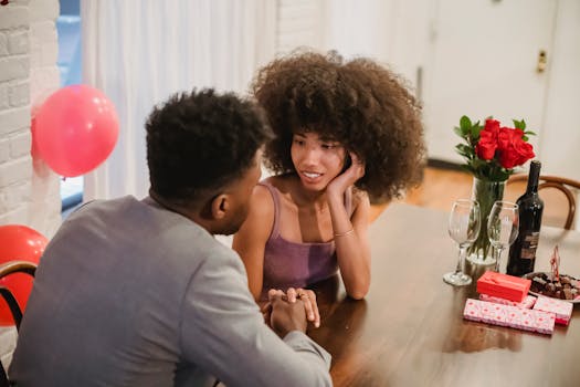 A couple sharing a romantic moment at a beautifully decorated dinner table with wine and gifts.