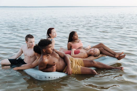 A diverse group of teenagers relaxing on a float in the sea, enjoying a summer vacation.